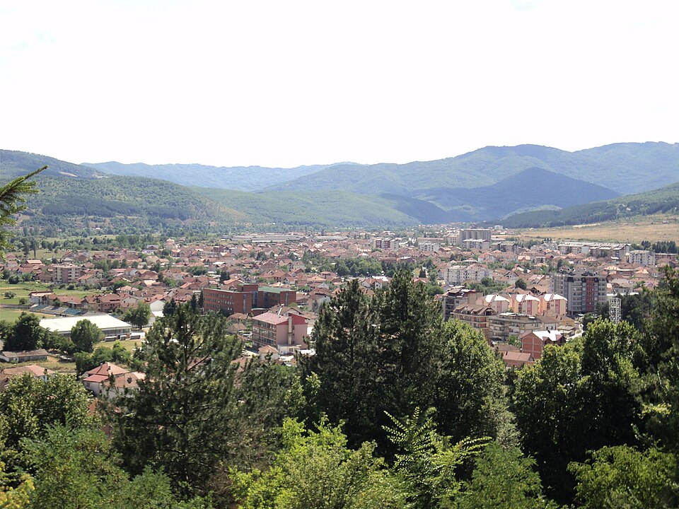 View over the town of Kičevo and its valley in western North Macedonia, with forested hills behind