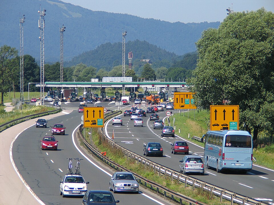 Traffic approaching the Log toll station on Slovenia's A1 motorway, with lorries at the toll booths